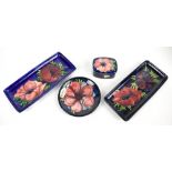 MOORCROFT; four pieces decorated in the 'Anemone' pattern comprising two rectangular pin trays, a