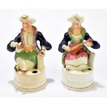 A pair of 19th century Staffordshire figural inkwells, representing Arab gentlemen, the second