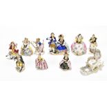 A collection of nine Continental hard paste porcelain miniature figures to include two Capodimonte