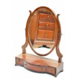 An Edwardian mahogany swing frame toilet mirror, with oval plate on base with three drawers and