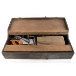 A tool chest housing a group of vintage tools including saw, chisels, brace, etc.Additional