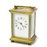 A late 19th century French brass cased carriage clock, the enamelled dial with Roman numerals,
