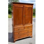 A 19th century mahogany converted press cupboard, the two panelled doors enclosing an arrangement of