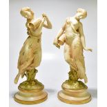 ROYAL WORCESTER; a large pair of blush ivory water carriers, each modelled as semi nude maidens