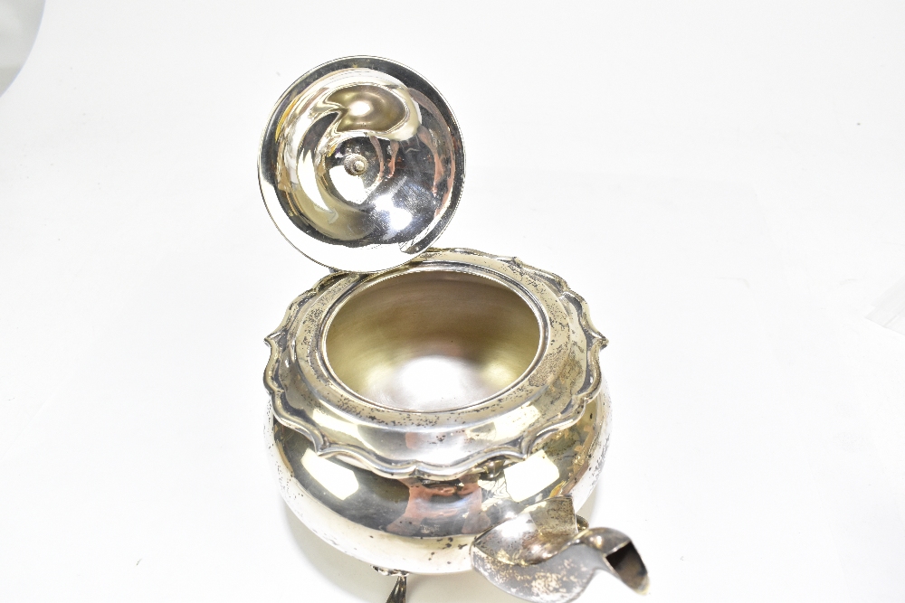 G BRYAN & CO; a George V hallmarked silver teapot of bulbous form with cast scrolling rim, - Image 5 of 5