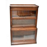 An early 20th century three section oak bookcase in Globe Wernicke or Gunn style, of waterfall