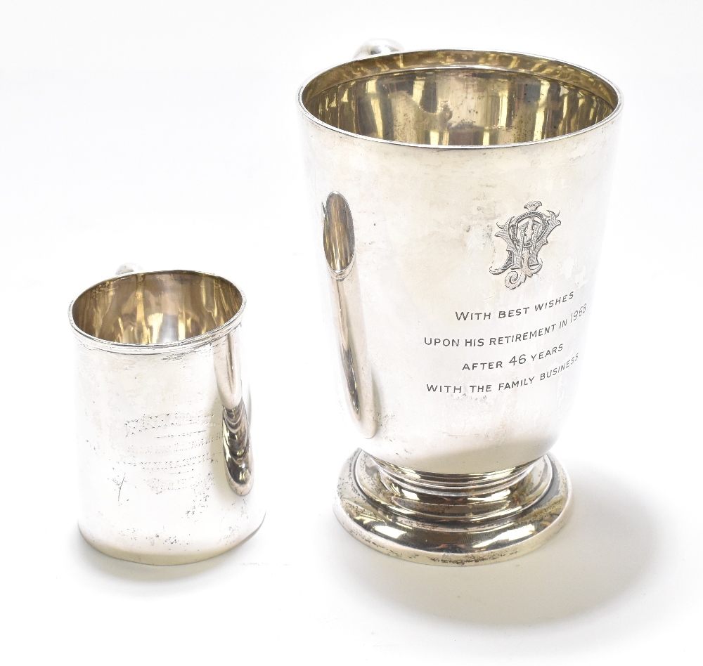 WALKER & HALL; a George V hallmarked silver mug with C-handle, on spreading circular foot, later