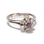 An 18ct yellow gold diamond and ruby flower head dress ring with central ruby above six small