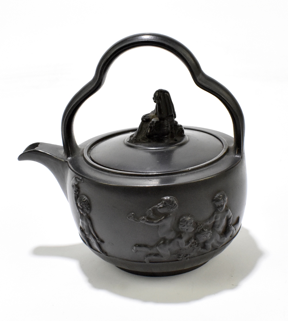 A late 18th century black basalt teapot and cover/rum kettle in the manner of Wedgwood and