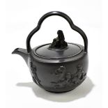 A late 18th century black basalt teapot and cover/rum kettle in the manner of Wedgwood and