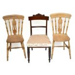 A pair of country kitchen chairs with pierced splats and solid seats on turned legs, height 85cm,