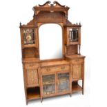 An Edwardian inlaid rosewood display cabinet, the raised back with an arched bevelled mirror flanked