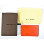 LOUIS VUITTON; a textured orange leather card wallet, initialled 'LV' to the lower corner, length