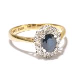 An 18ct yellow gold oval diamond and sapphire dress ring with central oval stone with border of tiny