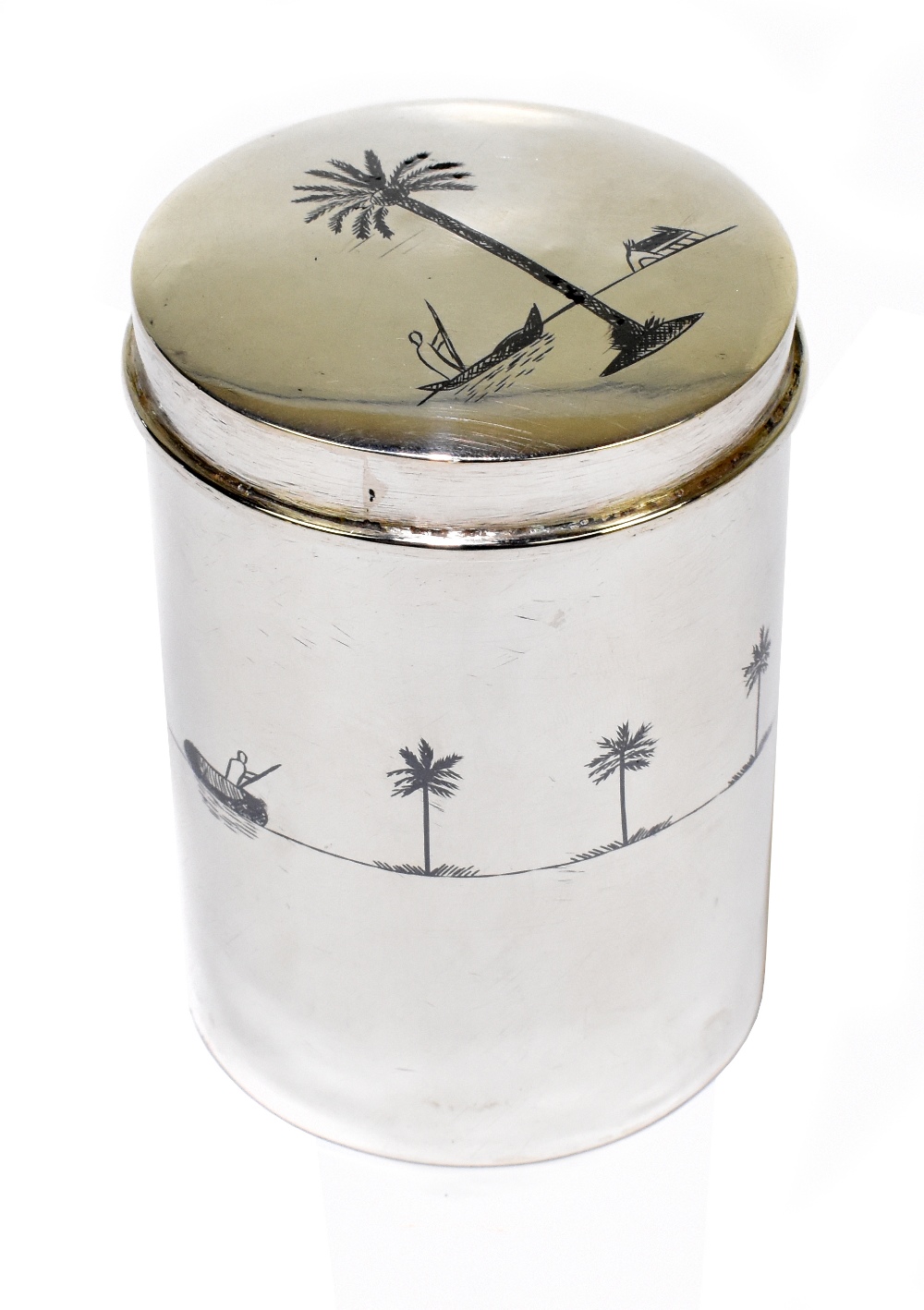 An Eastern white metal and niello decorated cylindrical tea canister and cover, the lid decorated