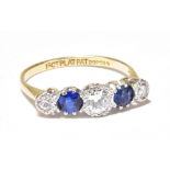 An 18ct yellow gold and platinum set diamond and sapphire ring, the central diamond weighing