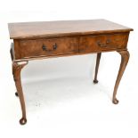 A 1950s walnut two drawer side table, raised on carved cabriole supports terminating on pad feet,