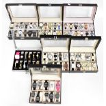 A large quantity of lady's and gentleman's fashion wristwatches all displayed in watch cases, by