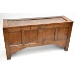An 18th century oak coffer with four panel front on stile supports, height 72cm, width 138.5cm,