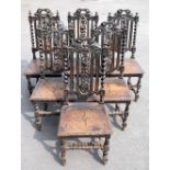 A set of six late 19th century Carolean style carved oak dining chairs, with solid seats on turned