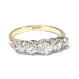 An 18ct yellow gold graduated five stone diamond ring, the central diamond weighing approx 0.70ct,