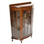 A 1930s mahogany bow front display cabinet, the single glazed door enclosing three shelves, height