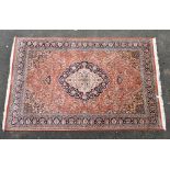 A cashmere bamboo silk carpet, with a central ivory and blue medallion against a red ground with