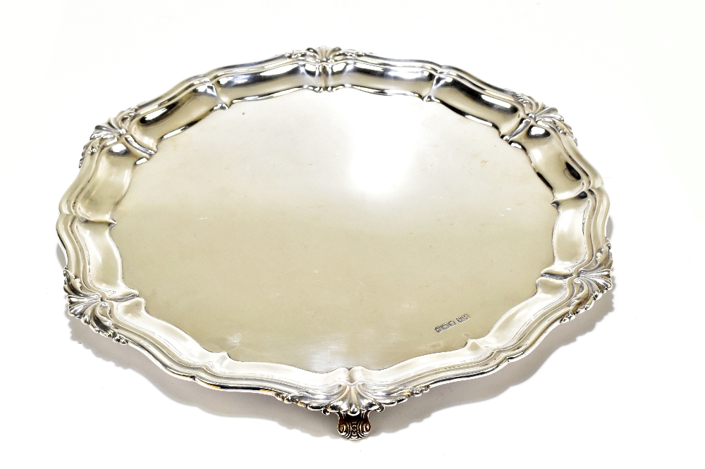 ATKIN BROS; a George V hallmarked silver salver raised on three scrolling supports, Sheffield