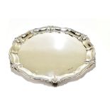 ATKIN BROS; a George V hallmarked silver salver raised on three scrolling supports, Sheffield