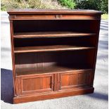 A 19th century walnut open fronted bookcase, with two adjustable shelves above two panelled cupboard