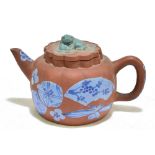 A 20th century Chinese earthenware Yixing teapot with slip decoration and moulded Dog of Fo