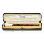 A leather cased simulated tortoiseshell and 9ct yellow gold mounted cheroot holder with trumpet
