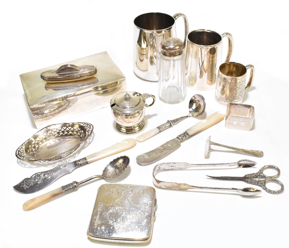 A group of variously hallmarked silver items comprising a cigarette box, two Christening mugs, a