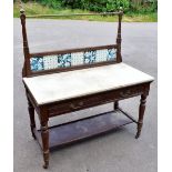 A late Victorian pitch pine marble top wash stand, the raised back inset with seven floral ceramic