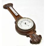 A late 19th/early 20th century carved oak barometer and thermometer, length 84cm.Additional