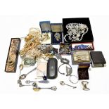 A quantity of costume jewellery including simulated pearls, brooches, various chains, etc.