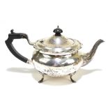 G BRYAN & CO; a George V hallmarked silver teapot of bulbous form with cast scrolling rim,