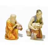 ROYAL WORCESTER; a pair of coloured blush ivory water carriers, each kneeling holding water urns,