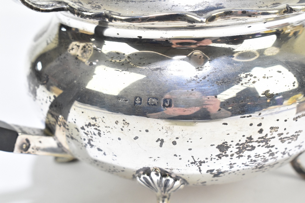 G BRYAN & CO; a George V hallmarked silver teapot of bulbous form with cast scrolling rim, - Image 2 of 5