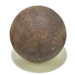 An antique cannonball, diameter 12cm.