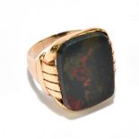 A yellow metal and large bloodstone set signet ring stamped 10k, size Q 1/2, approx 6.8g. Additional