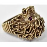 A 9ct gold ring in the form of a lion with red stone set eyes, stamped 375, size S, approx 17.2g.