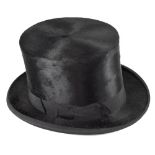 An early 20th century black top hat with dark green velvet makers cushion for J.