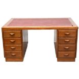 An early 20th century oak eight-drawer twin pedestal desk,