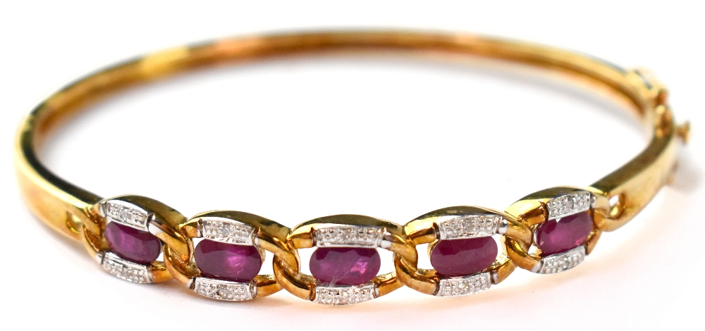 A 9ct gold diamond and ruby hinged bangle,