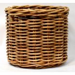 A large round modern wicker log basket, height 54cm, diameter 63cm.