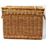 A very large modern wicker basket with heavy rope twist handles,