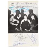 QUEEN; a black and white book page bearing the signatures of Freddie Mercury, Brian May,