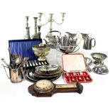 A large collection of silver plate to include two pairs of candlesticks, two three-piece tea sets,