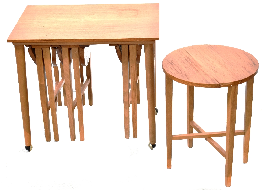 A 1960s retro teak coffee table containing four smaller gateleg drop-leaf tables,